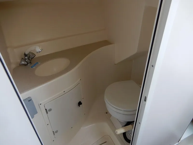 Slide: The Image of 1999 Pursuit 2860 Denali boat bathroom with sink and toilet. - 5