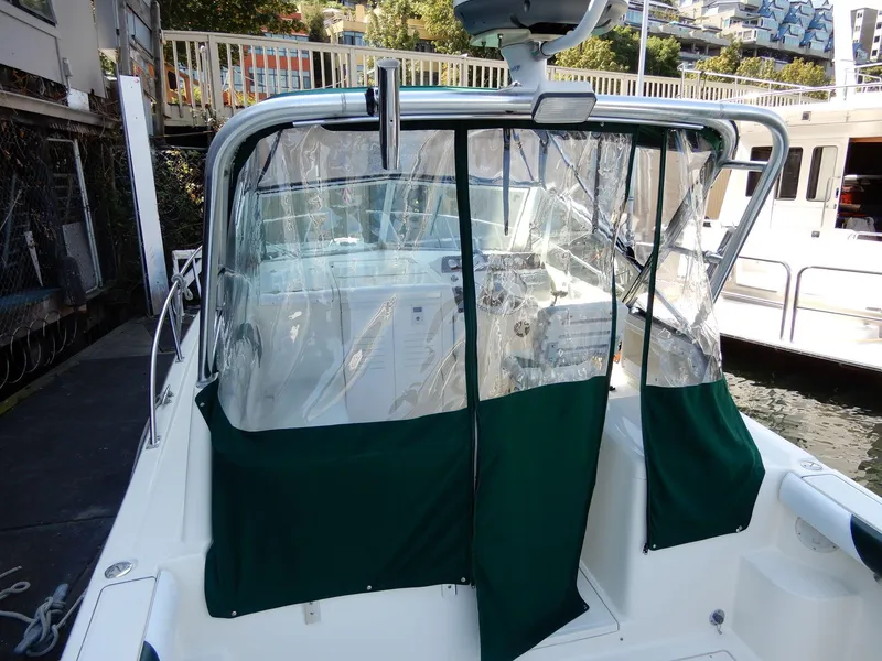 Slide: The Image of 1999 Pursuit 2860 Denali boat with green canopy docked at marina. - 7