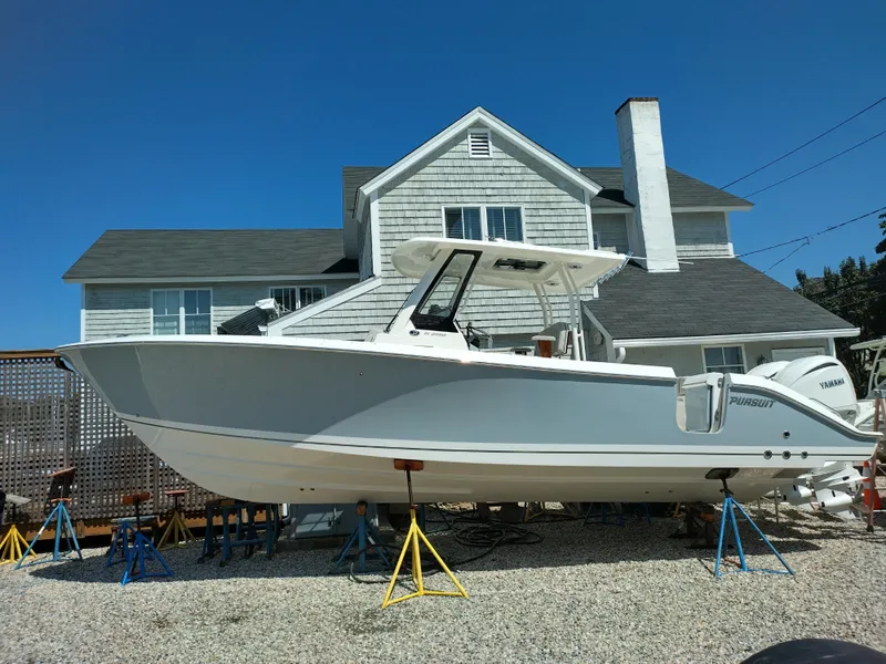 Slide: The Image of 2025 Pursuit S 288 Sport boat on stands in front of a house. - 10