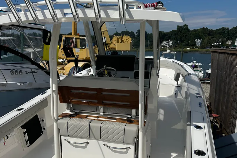 Slide: The Image of 2025 Pursuit S 288 Sport boat with sleek design, docked in a marina. - 2