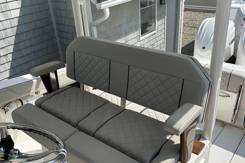 Slide: The Image of 2025 Pursuit S 288 Sport boat interior with cushioned seating and steering wheel. - 7