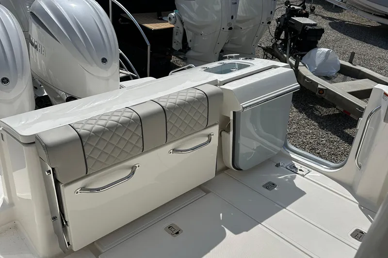 Slide: The Image of 2025 Pursuit S 288 Sport boat interior with cushioned seating and storage. - 8