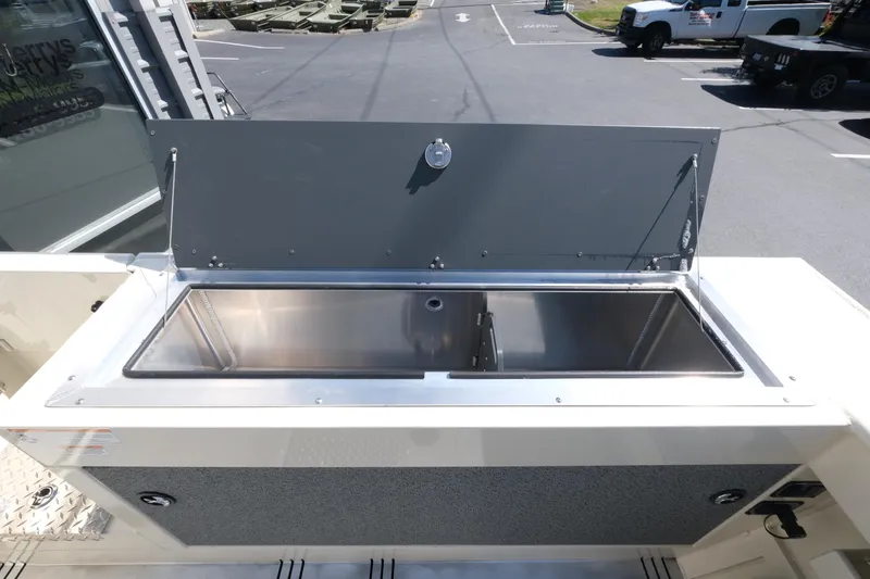 Slide: The Image of 2025 Hewescraft 220 Ocean Pro ET HT boat with open stainless steel storage compartment. - 18
