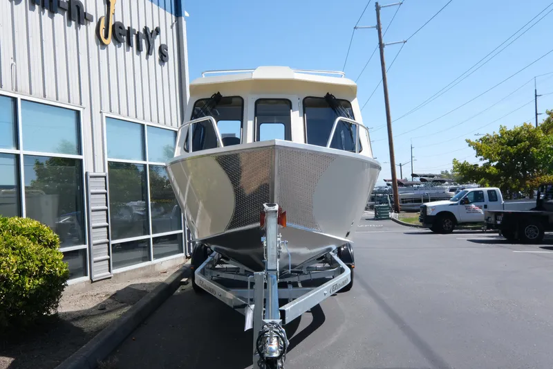 Slide: The Image of 2025 Hewescraft 220 Ocean Pro ET HT boat on trailer outside dealership. - 2