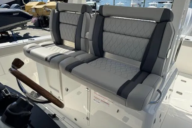 Slide: The Image of 2026 Pursuit S 328 Sport boat seats with quilted gray upholstery. - 13