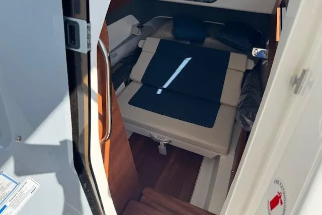 Slide: The Image of Interior cabin of 2026 Pursuit S 328 Sport boat with seating and cushions. - 17