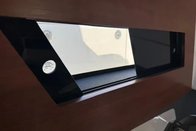 Slide: The Image of 2026 Pursuit S 328 Sport boat window with sleek black trim and wooden interior. - 20