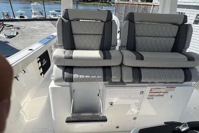 Slide: The Image of 2026 Pursuit S 328 Sport boat with luxurious seating and waterfront view. - 22