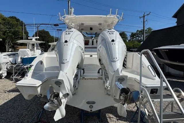 Slide: The Image of 2026 Pursuit S 328 Sport boat with dual outboard engines, displayed outdoors. - 3
