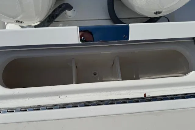 Slide: The Image of 2026 Pursuit S 328 Sport boat storage compartment with sleek design and white finish. - 9
