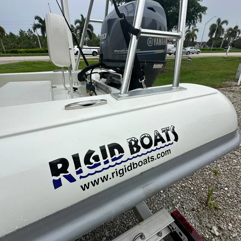 Slide: The Image of 2024 Rigid Boats 17' Sport with Yamaha engine, displayed outdoors. - 12