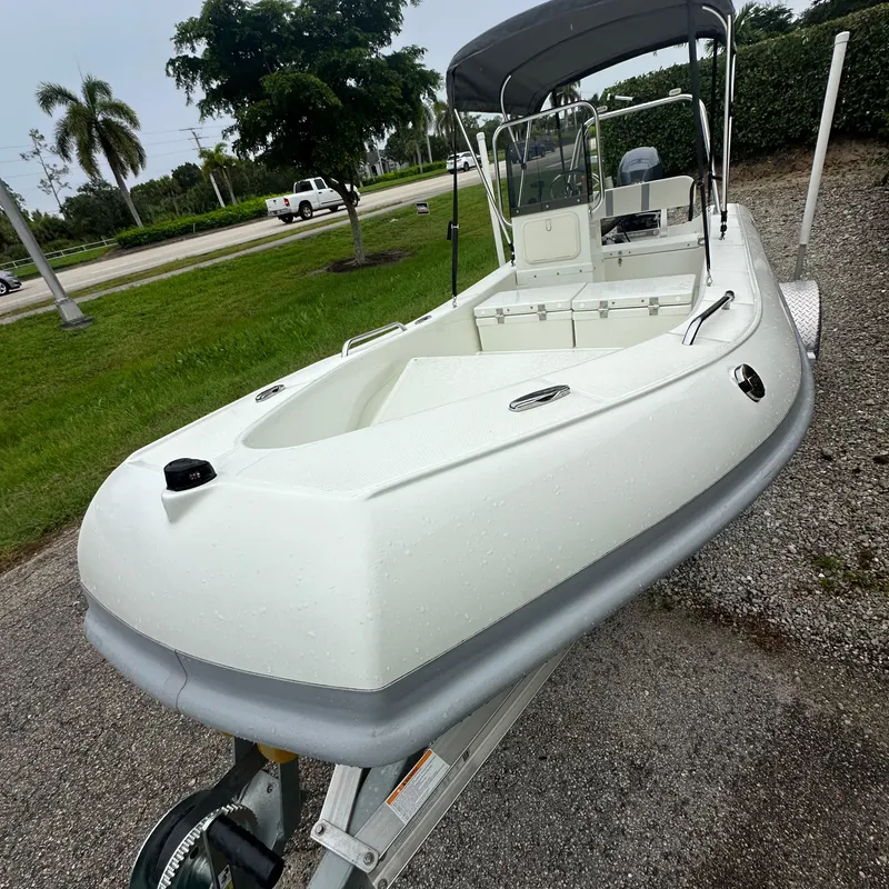 Slide: The Image of 2024 Rigid Boats 17' Sport on trailer, parked outdoors. - 13