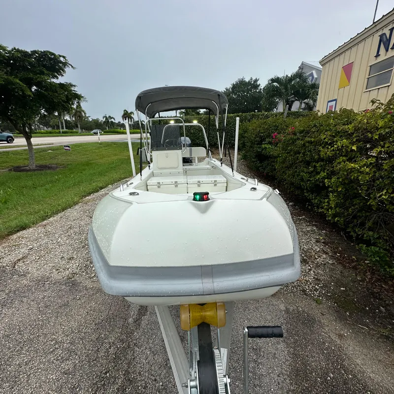 Slide: The Image of 2024 Rigid Boats 17' Sport on trailer, parked outdoors, overcast sky. - 15