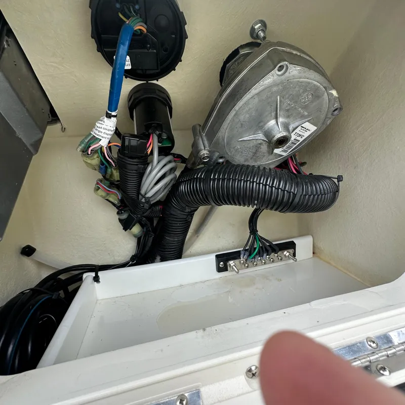 Slide: The Image of 2024 Rigid Boats 17' Sport electrical wiring and components inside compartment. - 3