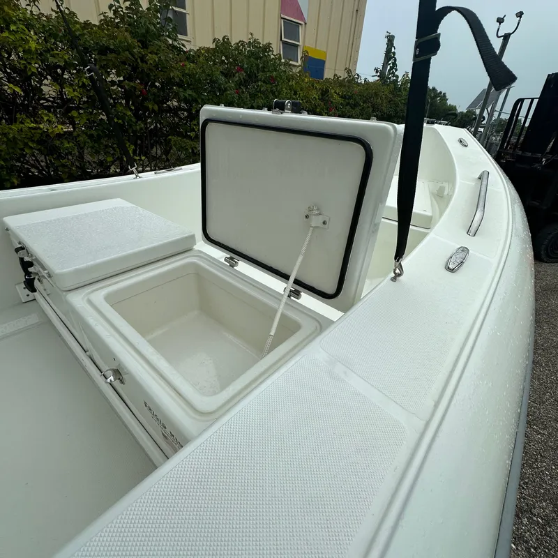 Slide: The Image of 2024 Rigid Boats 17' Sport with open storage compartment, white interior. - 4