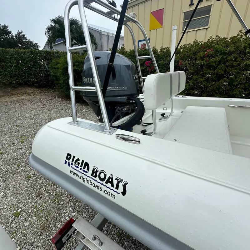 Slide: The Image of 2024 Rigid Boats 17' Sport with Yamaha engine, parked on gravel. - 6