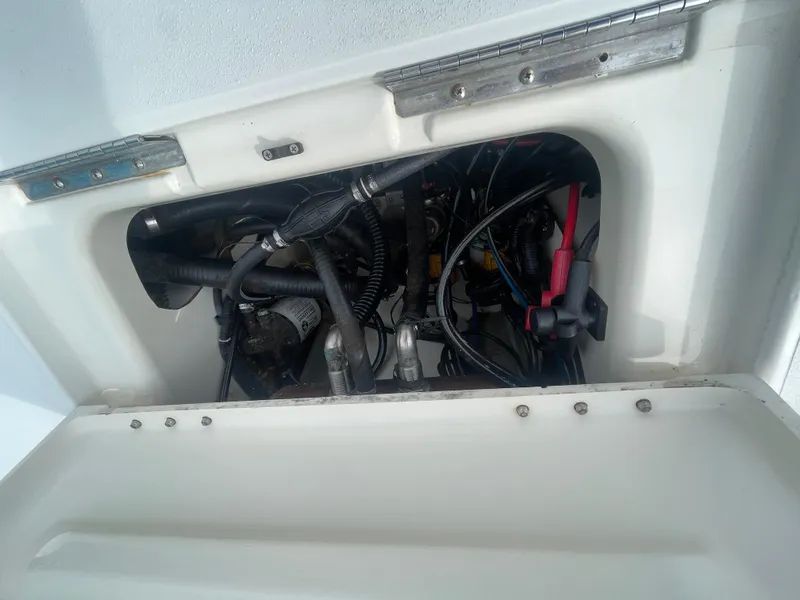 Slide: The Image of 2005 ShearWater 2200 boat engine compartment with visible wiring and components. - 10