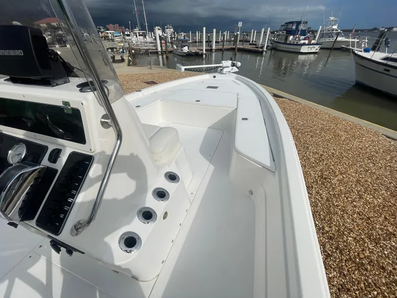 Slide: The Image of 2005 ShearWater 2200 boat docked at a marina, featuring a sleek white deck design. - 14