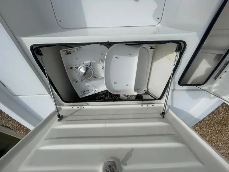Slide: The Image of 2005 ShearWater 2200 boat storage compartment with open hatch, showcasing interior details. - 17