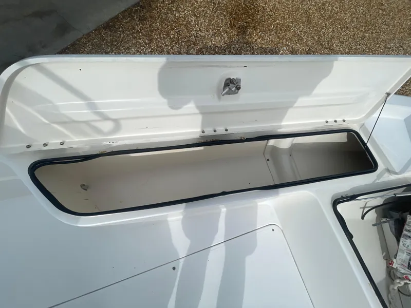 Slide: The Image of Open storage compartment on a 2005 ShearWater 2200 boat. - 21