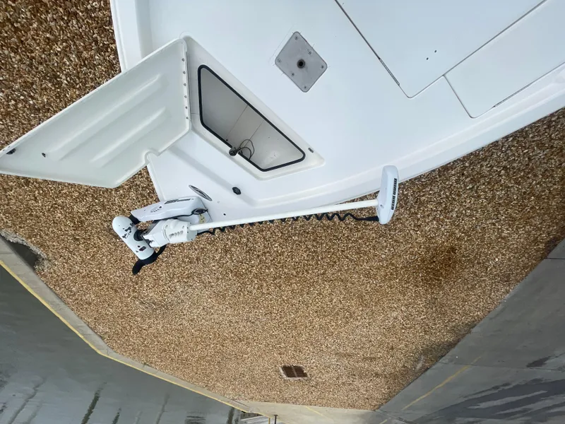 Slide: The Image of 2005 ShearWater 2200 boat with trolling motor on gravel surface. - 23