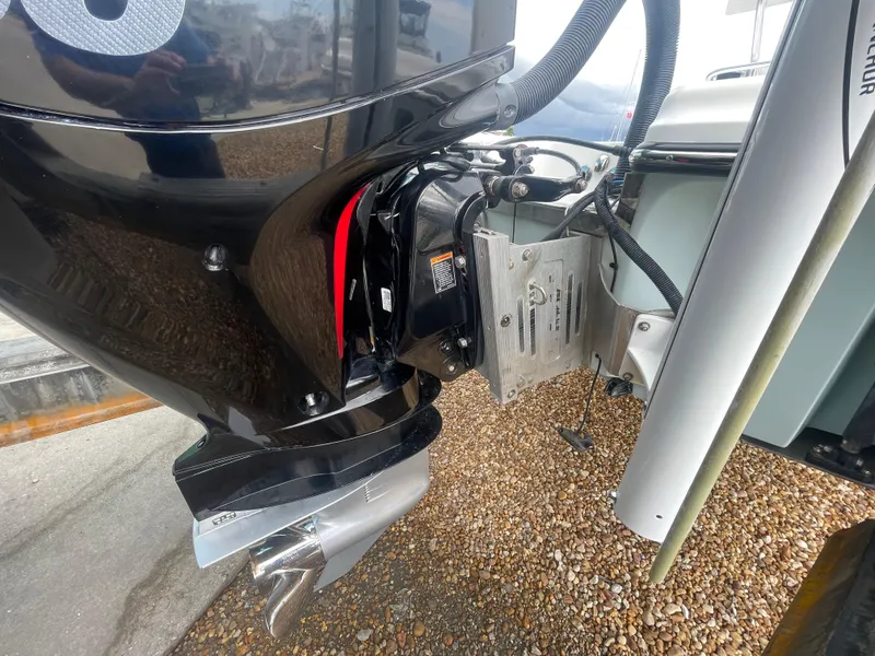Slide: The Image of Outboard motor of a 2005 ShearWater 2200 boat on gravel surface. - 26