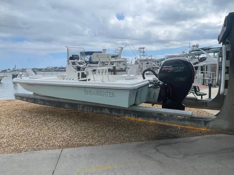 Slide: The Image of 2005 ShearWater 2200 boat on trailer at marina, featuring Mercury Pro XS engine. - 29