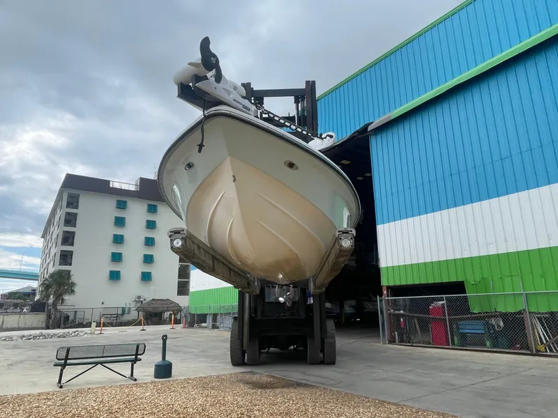 Slide: The Image of 2005 ShearWater 2200 boat being lifted from storage facility. - 30
