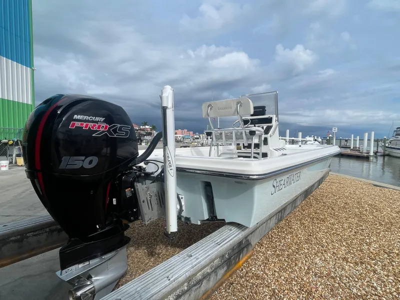 Slide: The Image of 2005 ShearWater 2200 boat with Mercury Pro XS 150 engine at a marina. - 4