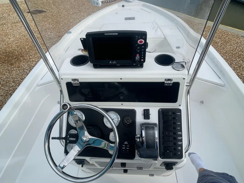 Slide: The Image of 2005 ShearWater 2200 boat console with steering wheel and navigation system. - 6