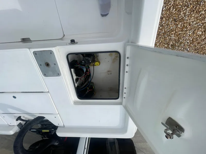 Slide: The Image of Open storage compartment on a 2005 ShearWater 2200 boat, showing internal wiring. - 9
