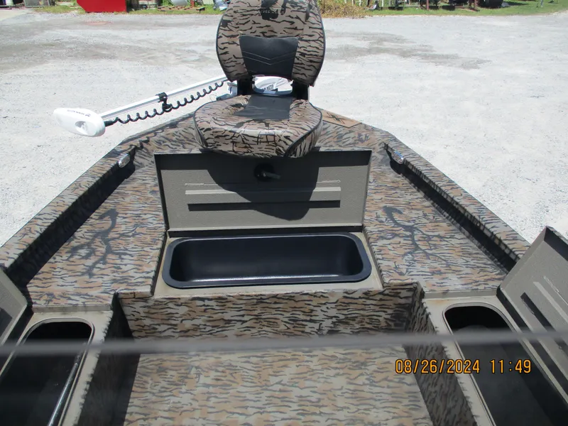 Slide: The Image of 2023 Express H20 Bay boat interior with camouflage seating and storage compartments. - 11