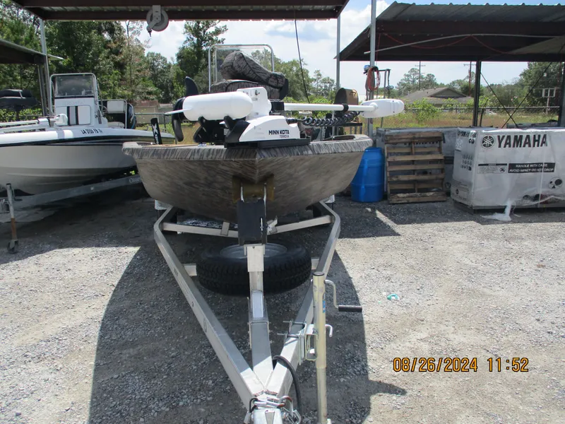 Slide: The Image of 2023 Express H20 Bay boat on trailer in outdoor storage area. - 13