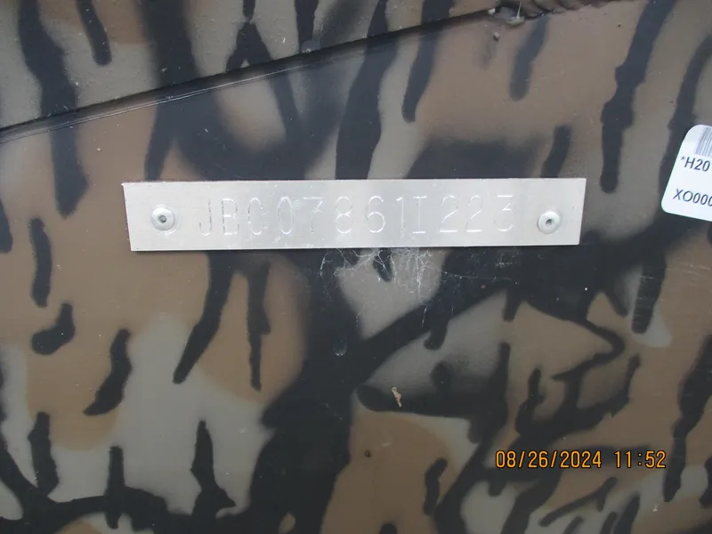 Slide: The Image of 2023 Express H20 Bay boat with camouflage pattern and identification plate. - 14