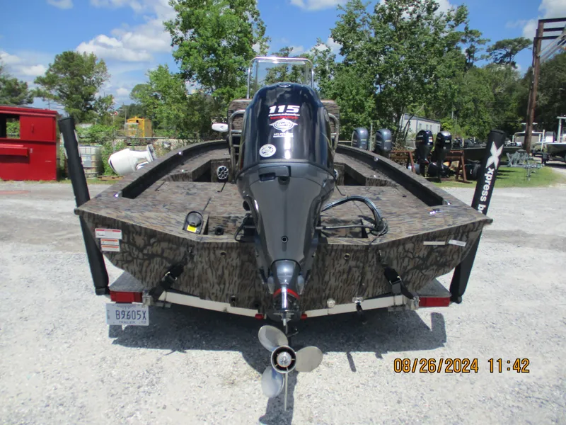 Slide: The Image of 2023 Express H20 Bay boat with powerful outboard motor, parked outdoors. - 3