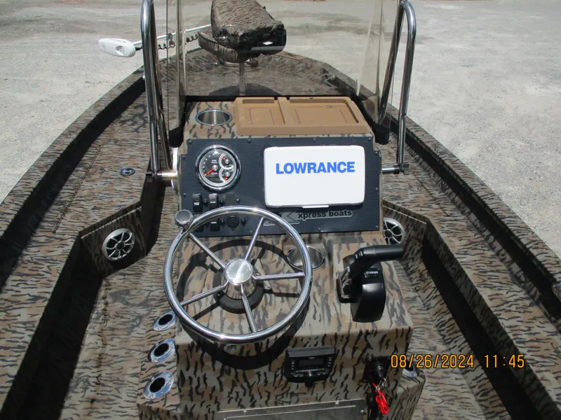 Slide: The Image of 2023 Express H20 Bay boat dashboard with Lowrance system and steering wheel. - 4