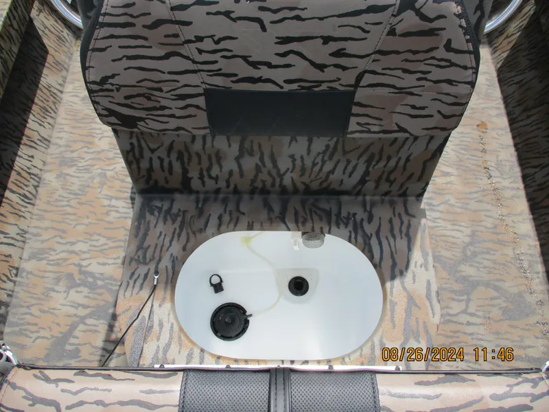 Slide: The Image of 2023 Express H20 Bay boat interior with camouflage design and built-in storage compartment. - 6