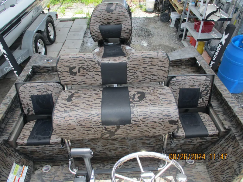 Slide: The Image of 2023 Express H20 Bay boat interior with camouflage seating and steering wheel. - 8