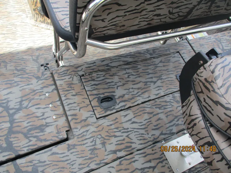 Slide: The Image of 2023 Express H20 Bay boat interior with camouflage pattern seating and flooring. - 9