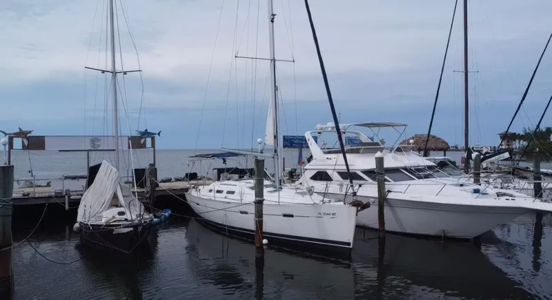 The Image of 2005 Beneteau Oceanis Clipper 373 sailboat docked at marina with other boats. - 0