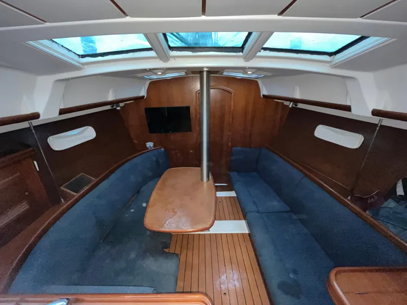 Slide: The Image of Interior of 2005 Beneteau Oceanis Clipper 373 sailboat with blue seating and wooden accents. - 10