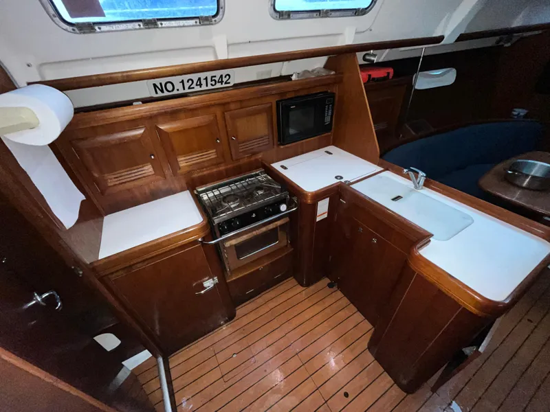 Slide: The Image of Interior of 2005 Beneteau Oceanis Clipper 373 yacht kitchen with wood cabinetry and appliances. - 12