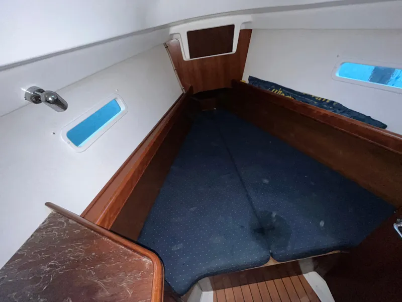Slide: The Image of Interior cabin of 2005 Beneteau Oceanis Clipper 373 sailboat, featuring cozy sleeping area. - 13