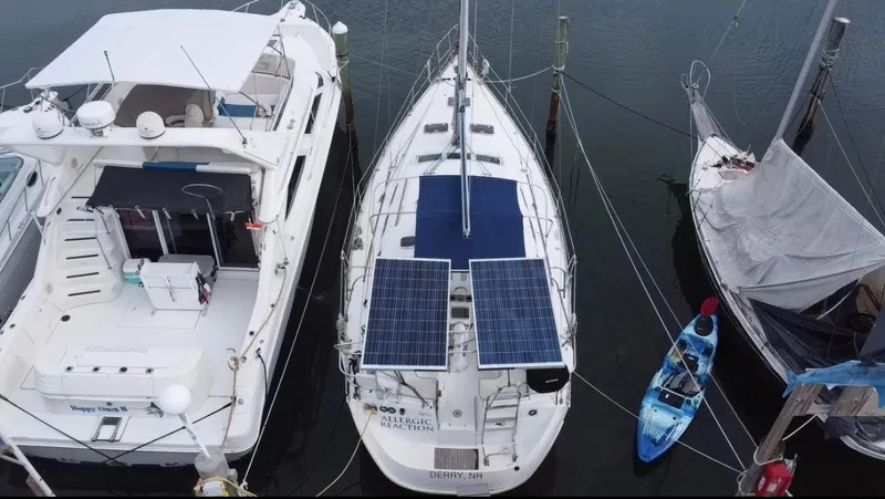Slide: The Image of 2005 Beneteau Oceanis Clipper 373 with solar panels docked between boats. - 2