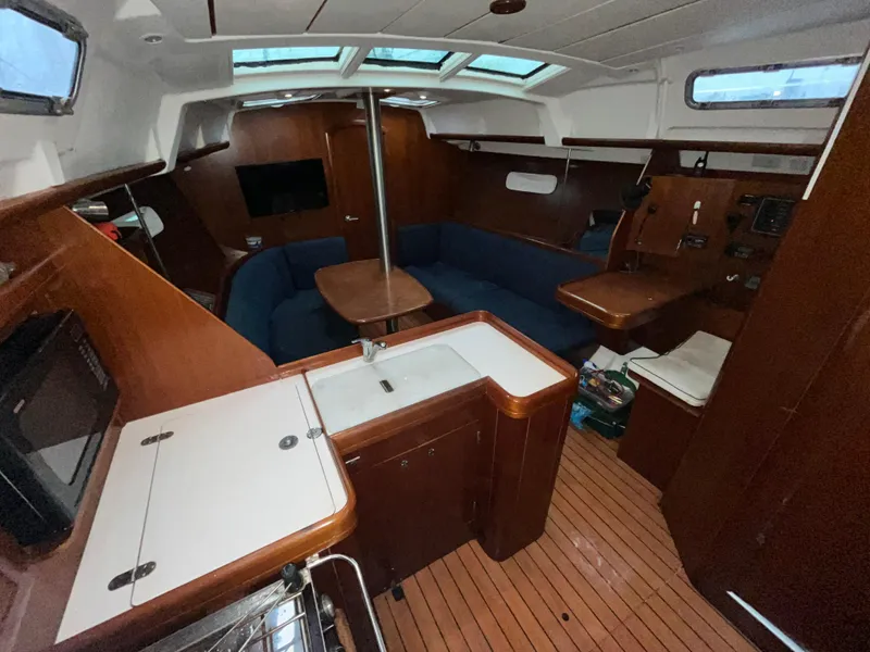Slide: The Image of Interior of 2005 Beneteau Oceanis Clipper 373 sailboat with wood finish and seating area. - 6