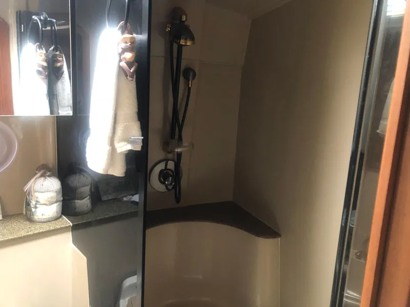 Slide: The Image of 2001 Cruisers Yachts 3672 Express bathroom with shower and towels. - 16