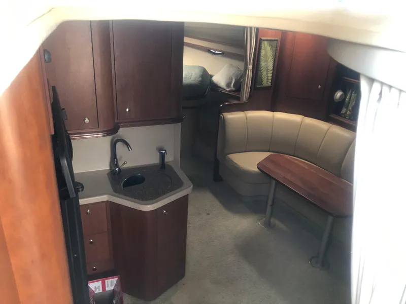Slide: The Image of Interior of 2001 Cruisers Yachts 3672 Express with kitchenette and seating area. - 25