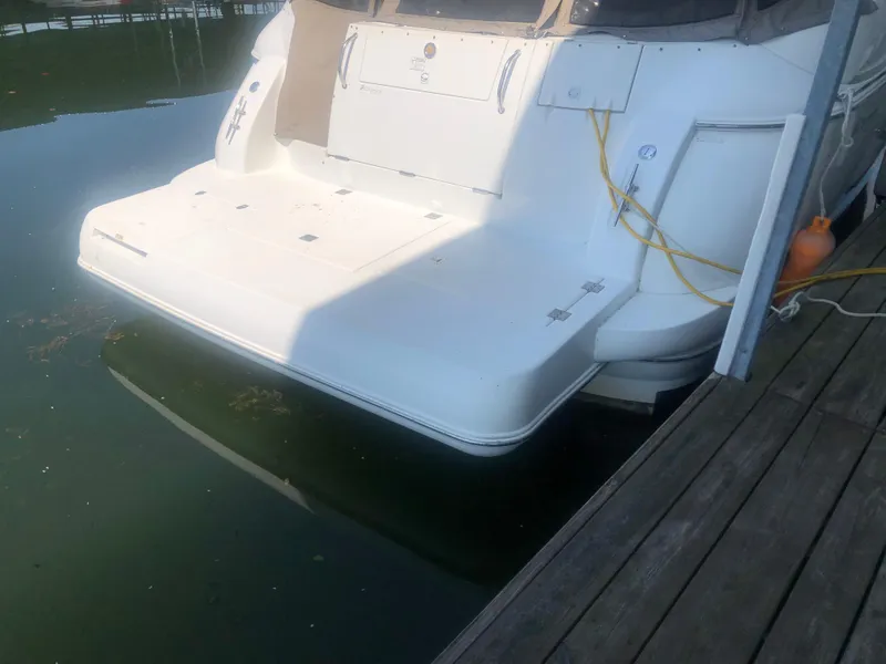 Slide: The Image of 2001 Cruisers Yachts 3672 Express docked, rear view with swim platform. - 4