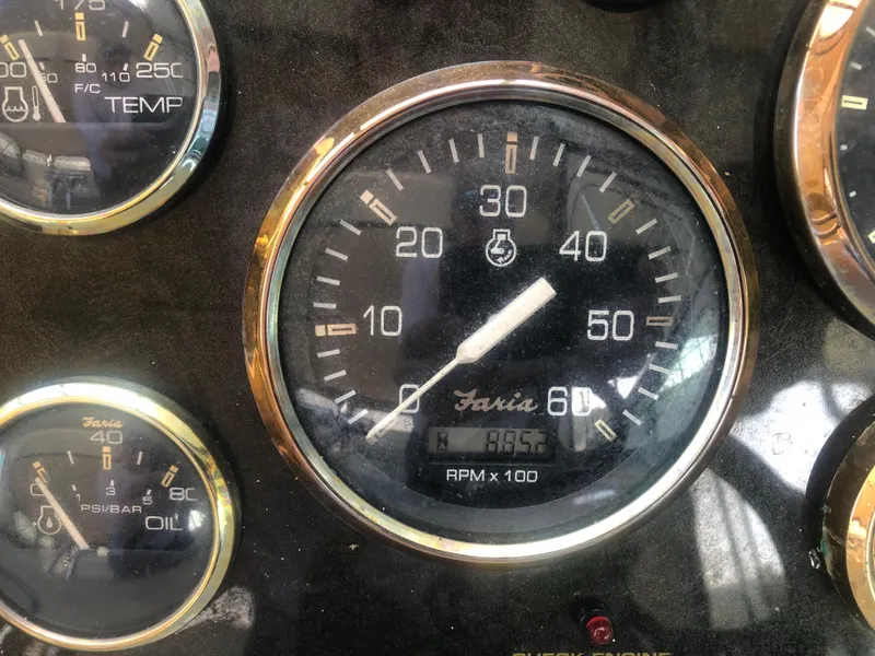 Slide: The Image of Close-up of 2001 Cruisers Yachts 3672 Express dashboard gauges, showing RPM and temperature. - 9