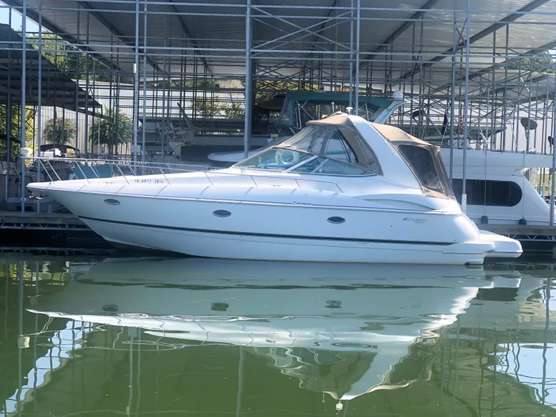 The Image of 2001 Cruisers Yachts 3672 Express docked in marina, side view. - 0